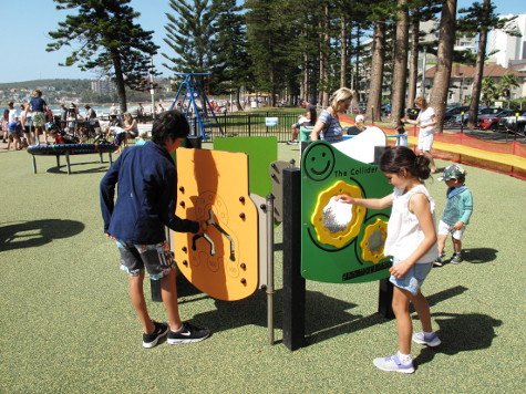 Child playinh with play panel at North Steyne Manly inclusive playground