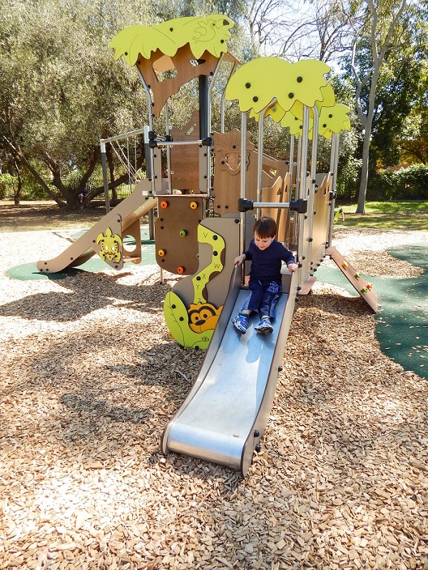 Child playing on a slide at Cummins Reserve Playground