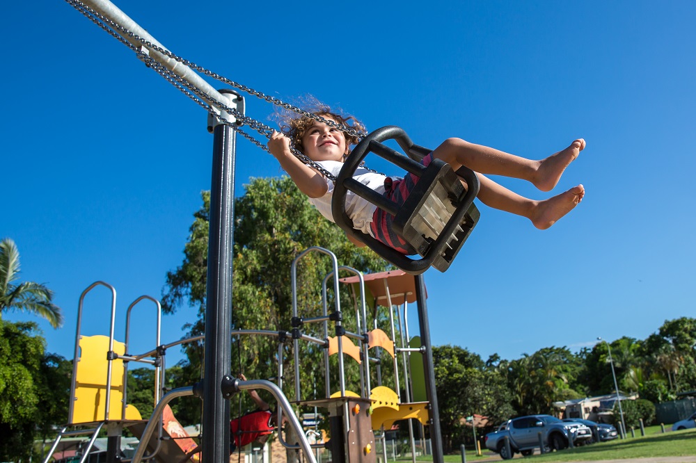 Child playing on a swing at Shang Street Park