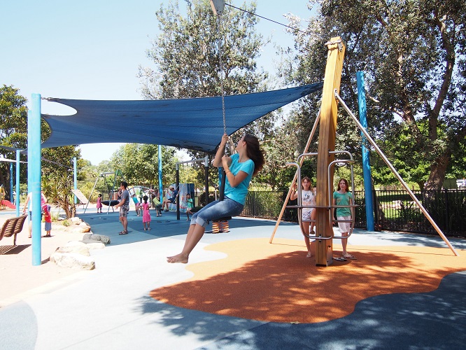 Child playing on a cableway at Flying Fox Park