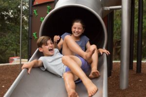 Child playing on a slide at Banjo Paterson Tower Playground