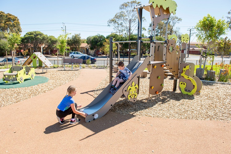 Child playing on a slide at St Clair Precinct 5 Playground