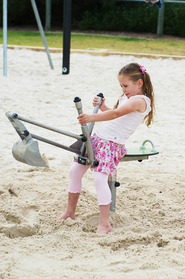 Child playing on a sand digger at Lennox Reserve Play Space