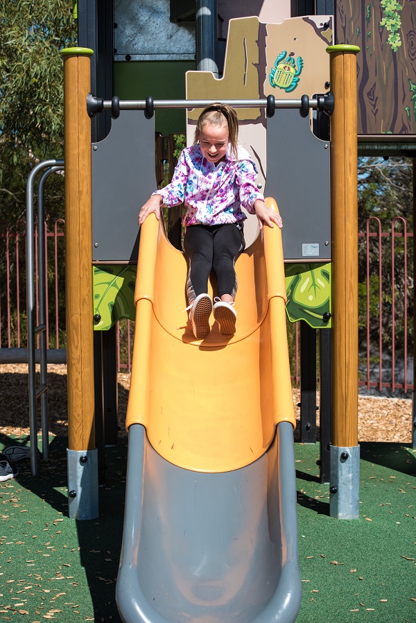 Child playing on a slide at Hilltop Playground