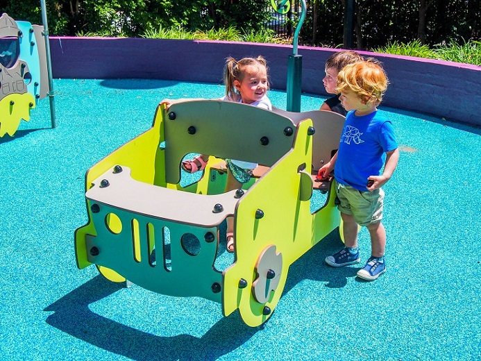 Child playing with car at Mona Vale Village Park Playground
