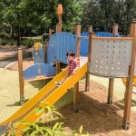 Child playing on a slide at Golden Grove Playground