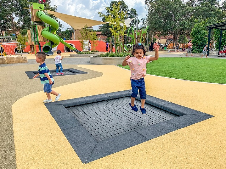 Child playing on a trampoline at Ollie Webb Reserve all-inclusive playground