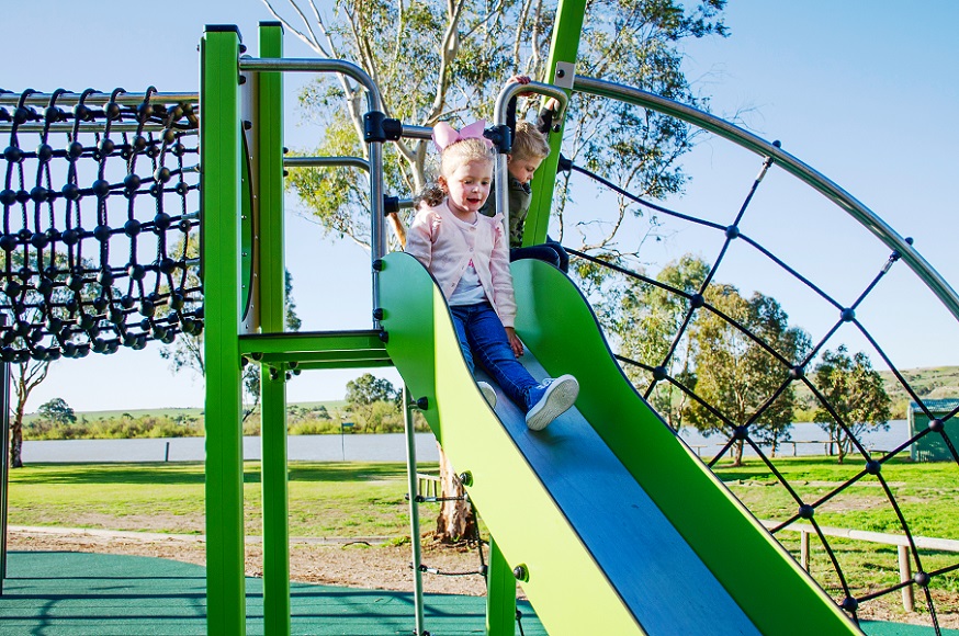 Child playing on a slide at Woodlane Reserve Playground