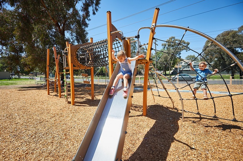 Child playing on a slide at Austin Crescent Reserve playspace