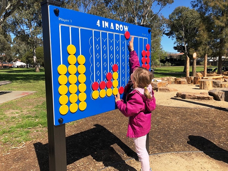 Child playing with play panel at Elsternwick Park Playground