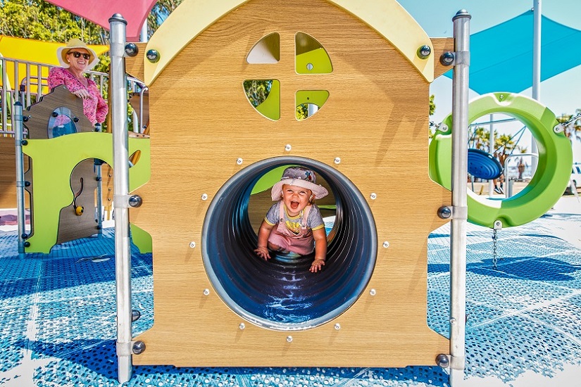 Baby in Elf Playhouse crawl tunnel