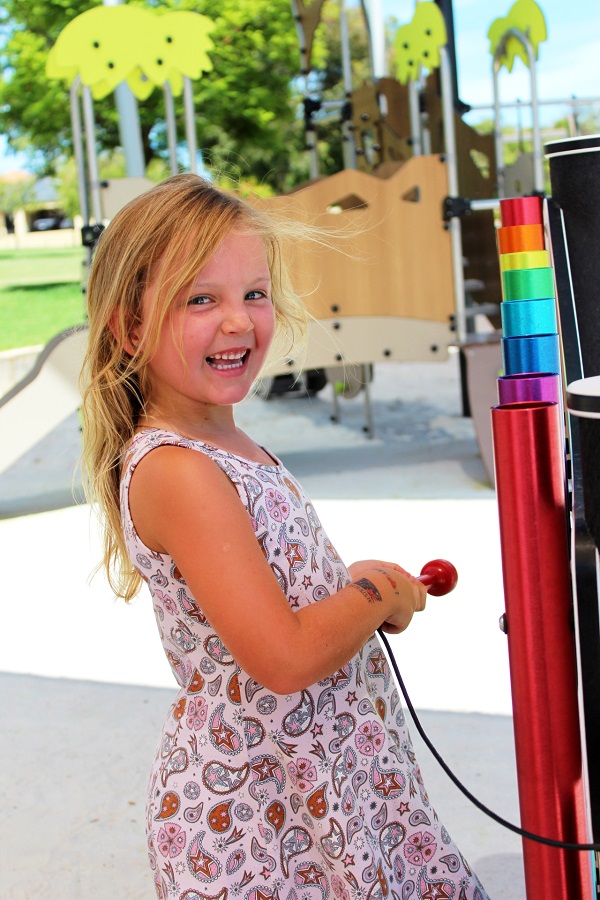 Child playing with musical equipment at Covent Park Pearsall Playground