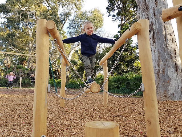 Child playing on a nature trail at Kooyong Gardens Playground
