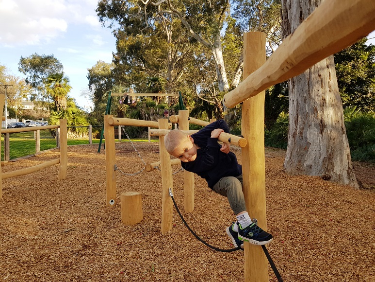 Child playing on a nature trail at Kooyong Gardens Playground