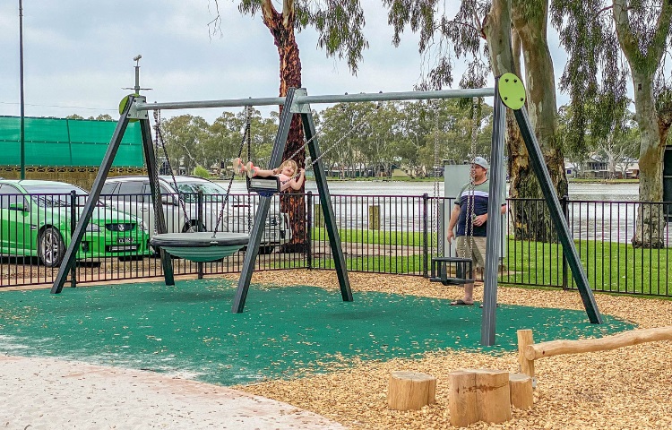 Child playing on a swing at Mary Ann Reserve Playspace