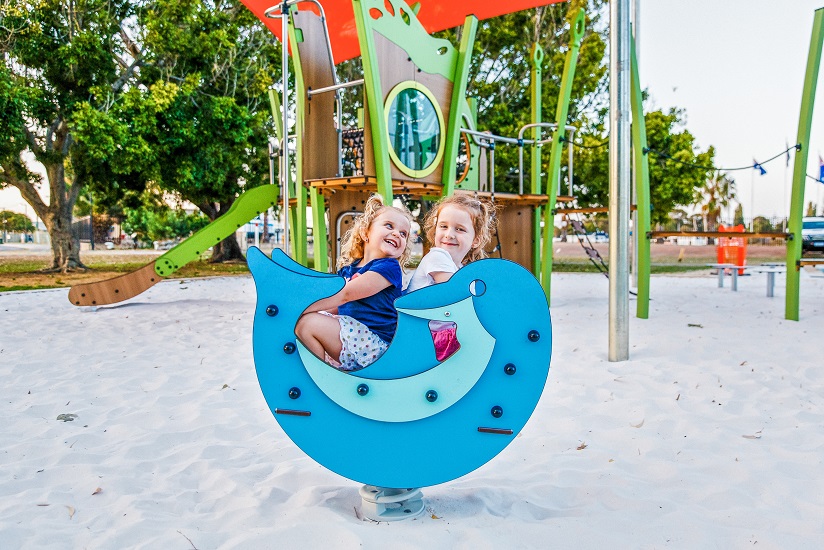 two children on a dolphin springer at Queens Garden playground