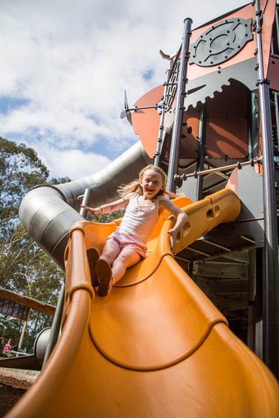 Child playing on a slide at Banjo Paterson Tower Playground