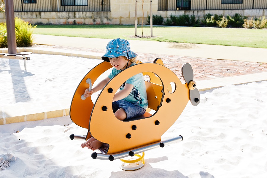 Child playing on a helicopter springer at Bromley Street Reserve Playground