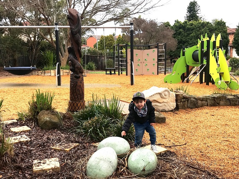 Child playing with Dino eggs at Darlington Drive Playground