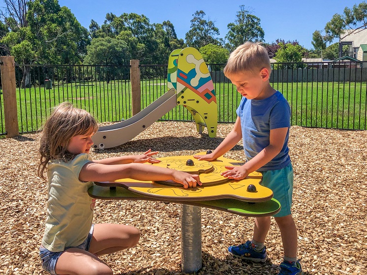 Child playing with play table at Eric Taylor Reserve Playground