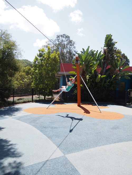 Child playing on a cableway at Flying Fox Park