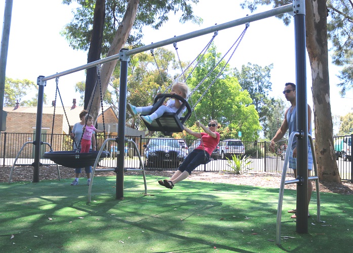 Child playing on a swing at Frank Beckman Playground