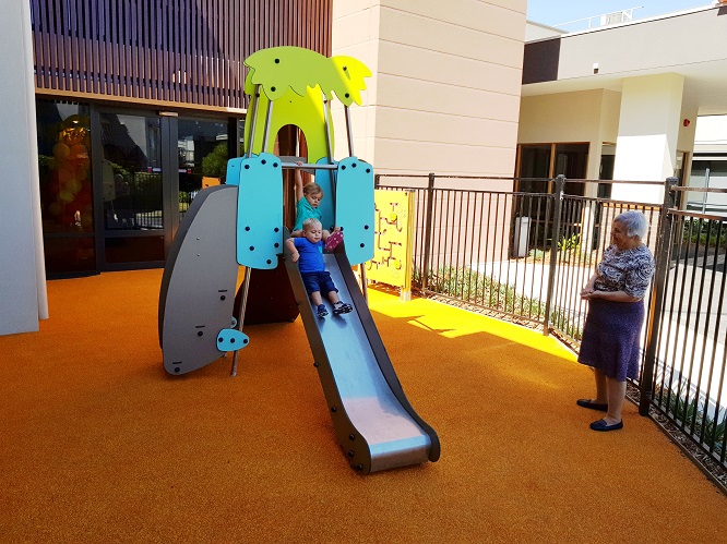 Child playing on a slide at Lexington Gardens Aged Care