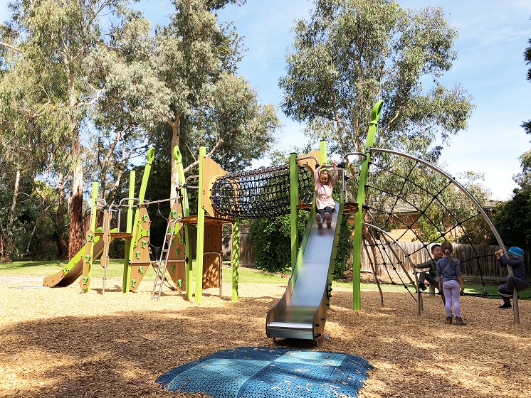 Child playing on a slide at Naughton Patch Playspace