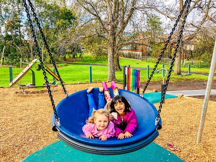 Child playing on a swing at Rialto Reserve Playground