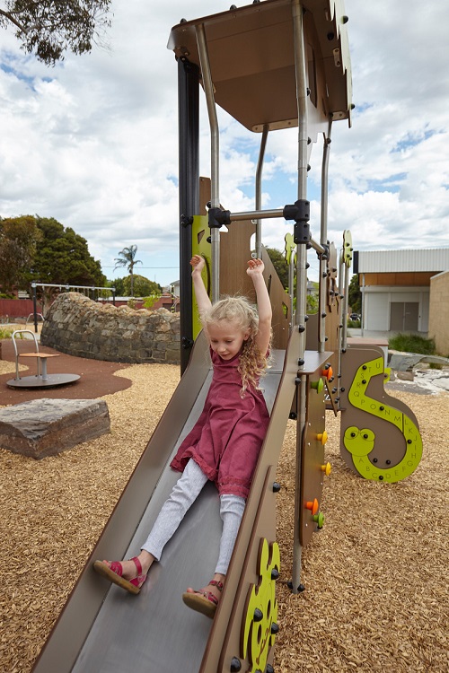 Child playing on a slide at Ruthven Reserve play space