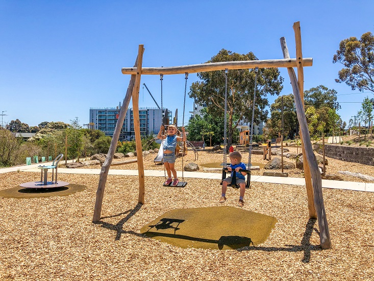 Child playing on a swing at Sheils Reserve Themed Playground