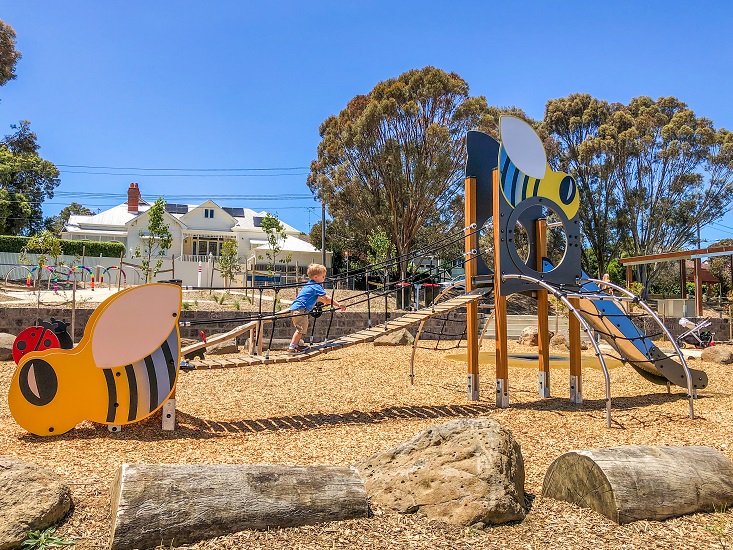 Child playing at Bee play unit at Sheils Reserve Themed Playground