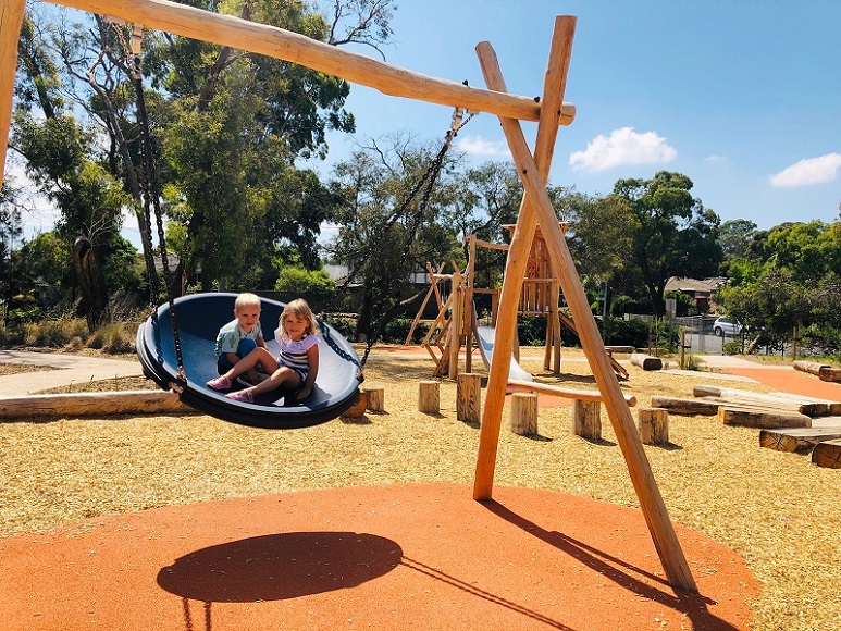 Child playing on a swing at Southgateway Reserve Playground