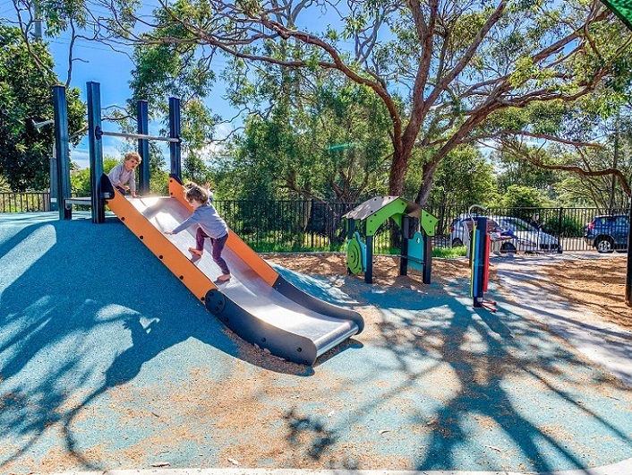 Child playing on a slide at Tania Park Playground