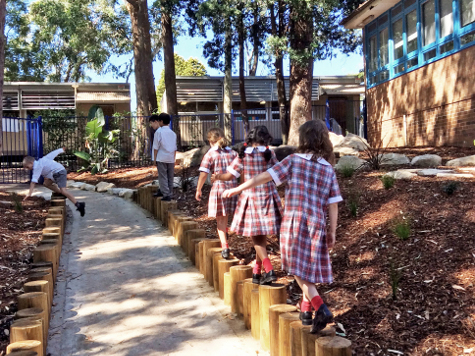 Children balancing on logs at Warrawee Care Centre