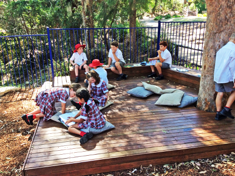 Children socialising on a timber stage at Warrawee Care Centre