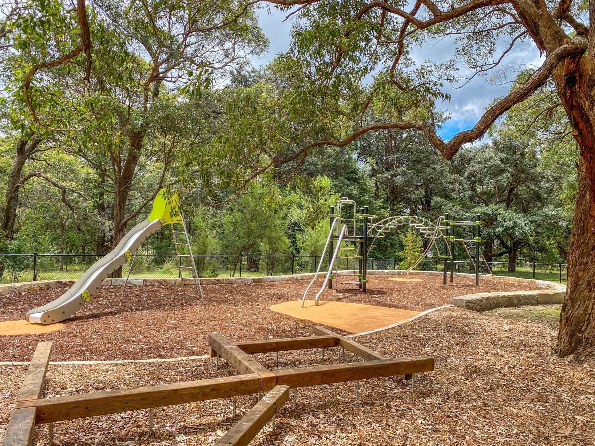 Adventure trail with slide and climbing structure at Queen Elizabeth Park Playground