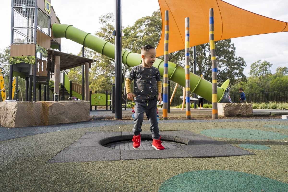 Boy with down syndrome jumping on a trampoline