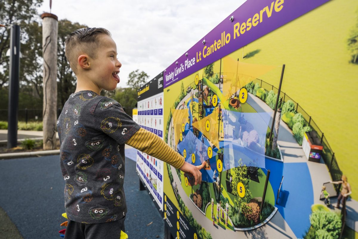 Boy with down syndrome looking at playground map