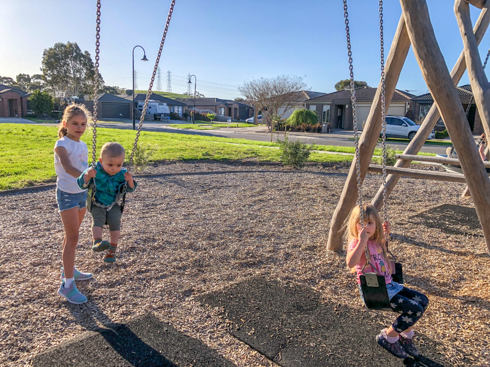 Children on swing set at Walnut Way Playground