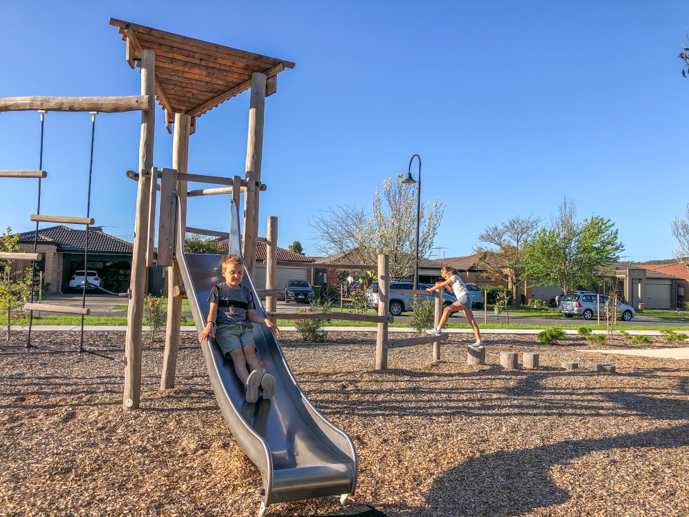 Children playing on Origin' Multi-Play Structure at Walnut Way Reserve Playground