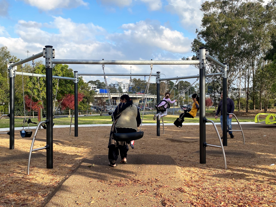 People on swings at International Peace Park Playground, Hammondville