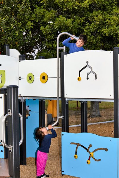 Children playing with talking tubes at Kitchener Park Playground