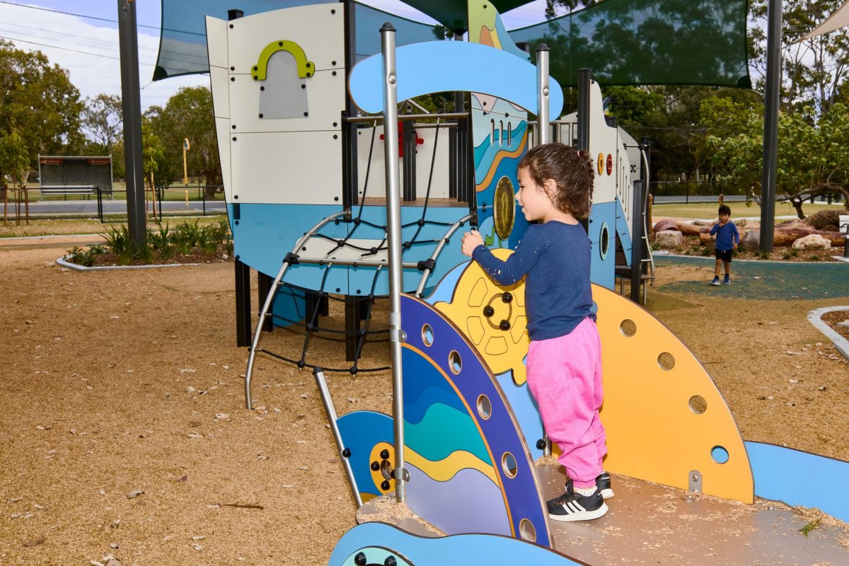 Child playing on Calypso river boat play equipment