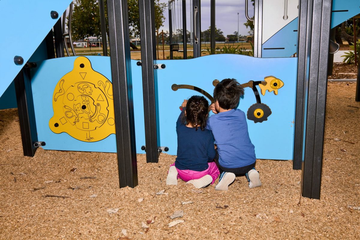 Children playing with manipulative play panels