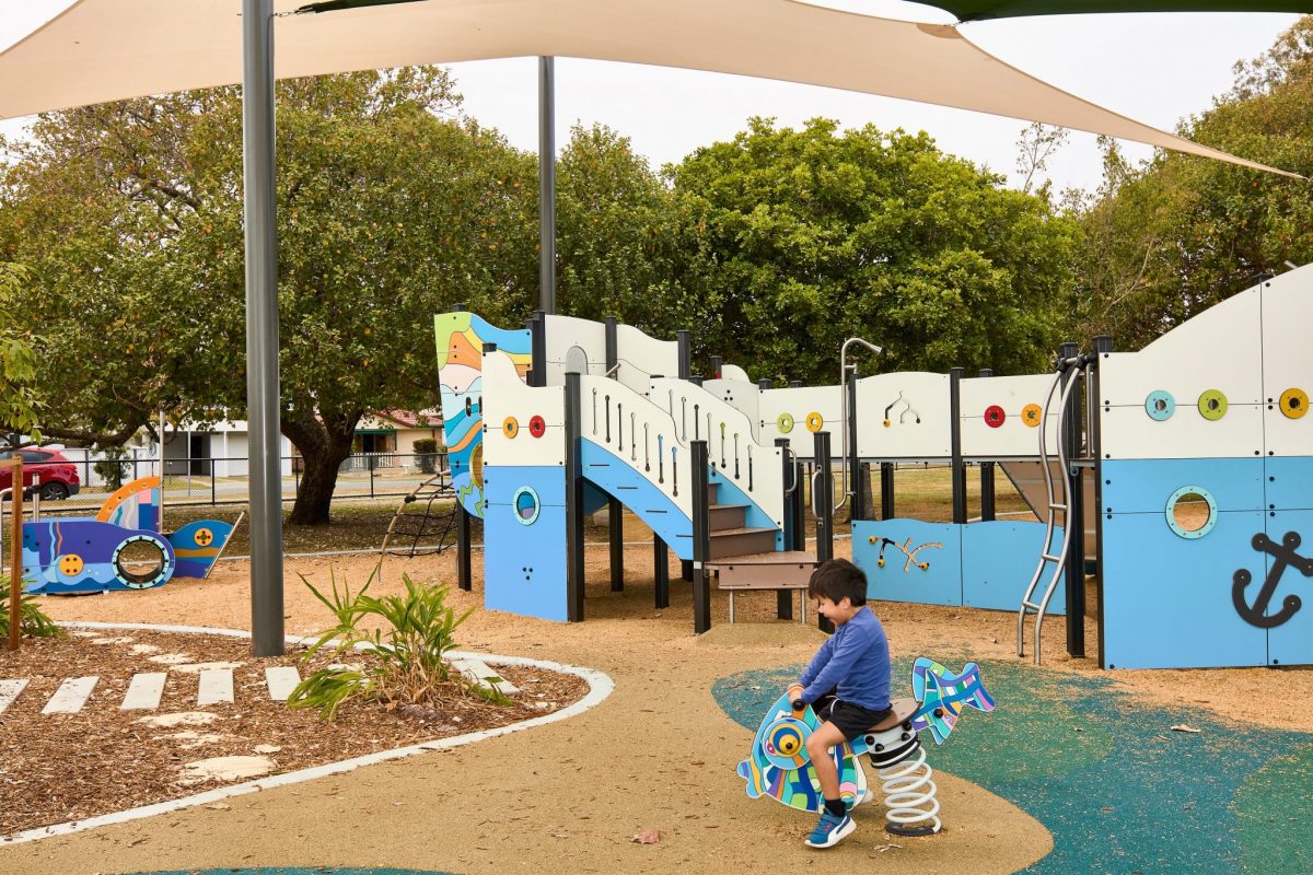 Child on fish springer at playground