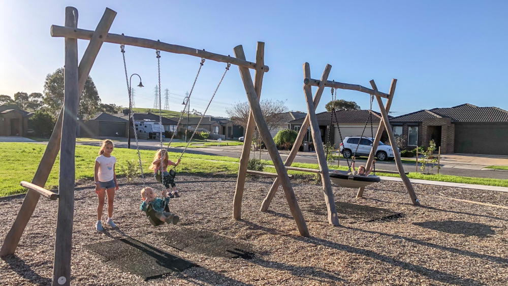 Children on combination swing set