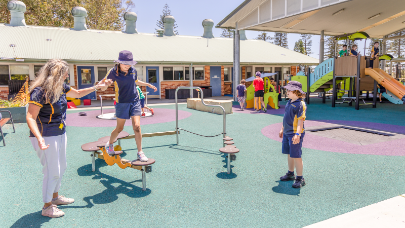 Carer is supporting child on a balancing circuit