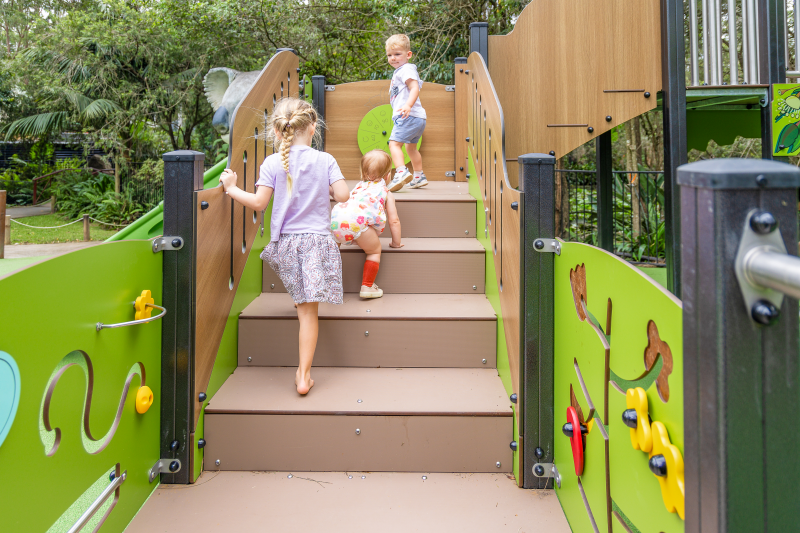 Children climbing up the staircase of play tower