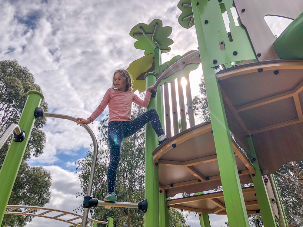 Child climbing on play tower
